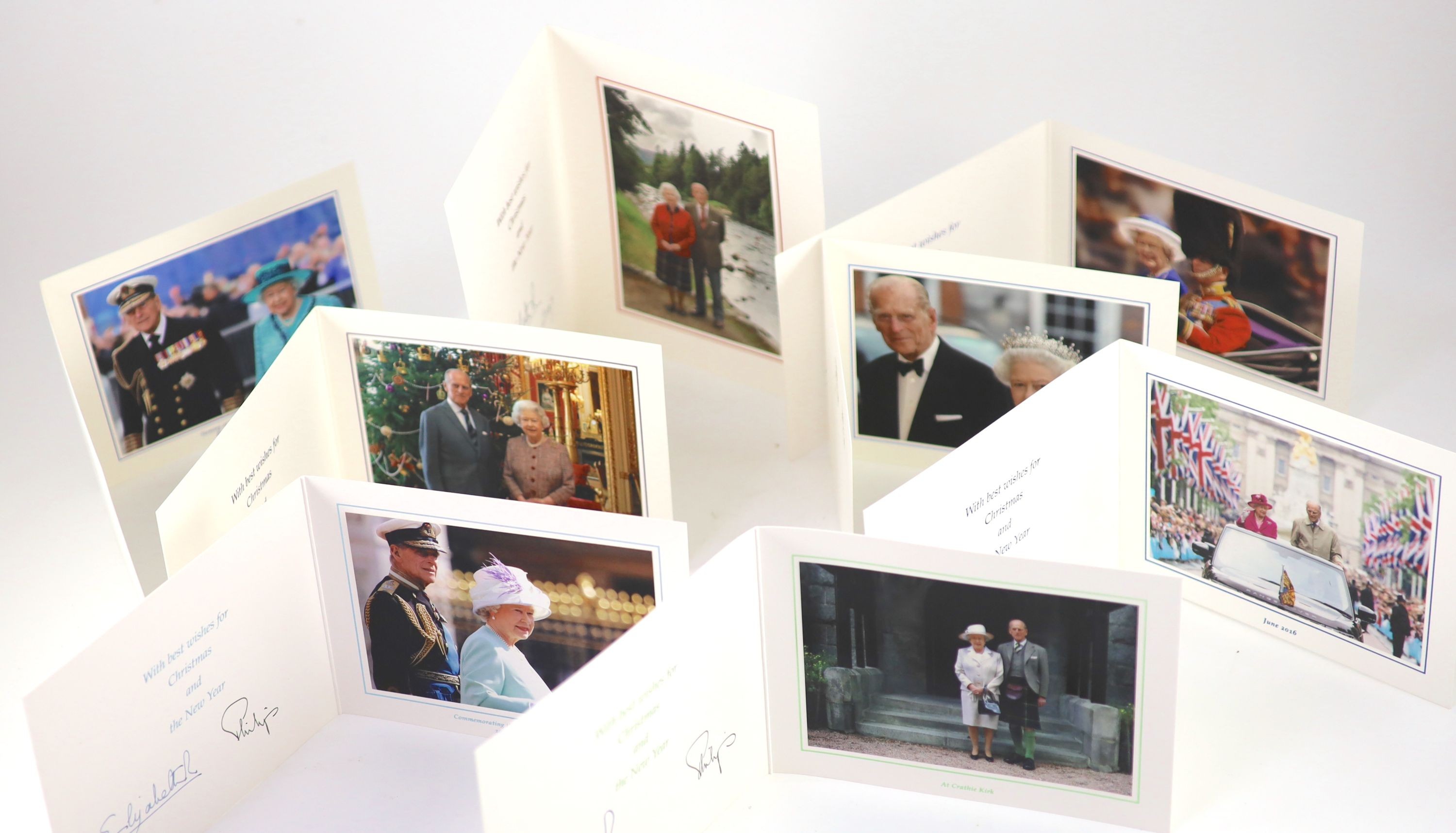 Elizabeth II, Queen of England, Philip, Prince, Duke of Edinburgh - a collection of 9 colour photographs, sent as Christmas cards, for the years 2003, 2005-06, 2008 and 2014, portraying and signed by the Queen and the Du